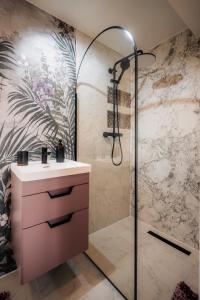 a bathroom with a sink and a shower at Casa Familiei Dambovicioara in Podu Dîmboviţei
