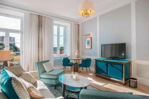 a living room with a couch and a tv at Hilton Imperial Dubrovnik in Dubrovnik
