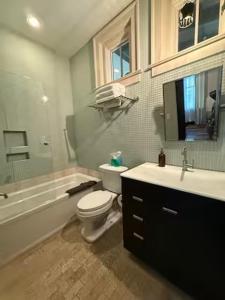 a bathroom with a tub and a toilet and a sink at Aspen Courtyard Residence in Buena Vista +4 photos