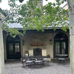 a patio with a table and chairs in front of a building at Aspen Courtyard Residence in Buena Vista