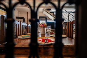 a table with wine glasses and flowers on top of it at Casa Familiei Dambovicioara in Podu Dîmboviţei +75 photos