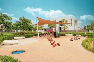 a park with a playground with slides and play equipment at Upscale 4BR Villa, Bali Pool, Resort Escape in Dubai +67 photos