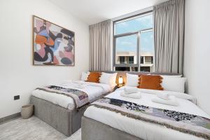 a hotel room with two beds and a couch at Upscale 4BR Villa, Bali Pool, Resort Escape in Dubai