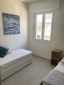 a bedroom with two beds and a window at casa mare in Cattolica