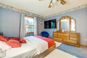 a bedroom with a bed and a dresser and a mirror at Families Welcome! Spacious Suburban Home in Dayton in Murlin Heights