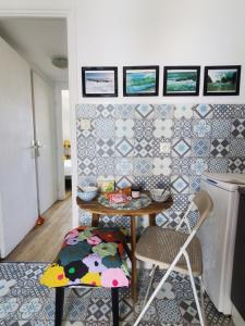 een tafel en stoelen in een keuken met tegels aan de muur bij Bel appartement centre Le Palais in Le Palais