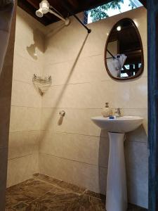 a bathroom with a sink and a mirror at La cabaña de puente palo in La Cumbre