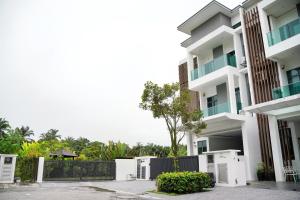 an apartment building with a fence in front of it at Cyberjaya Luxury Pool Villa Corner lot 16-20 pax in Puchong
