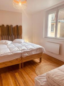 a bedroom with a large bed and a window at La Parenthèse Marine in Étaples