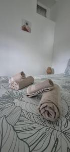 a bed with towels sitting on top of it at Chambre Étape Isabielle in Saint-Vaury
