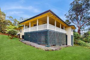 a house with a green lawn in front of it at Hale ʻAina Kai in Kuhio Village