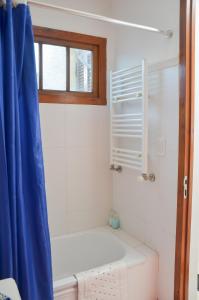 a bathroom with a toilet and a window at Posada Los Angelos in Ramallo