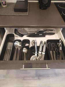 a drawer filled with utensils in a kitchen at Duplex cosy Gosselies - 4km aéroport et commerces in Charleroi