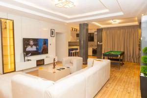 a living room with a white couch and a table at Steeze Apartment in Mama