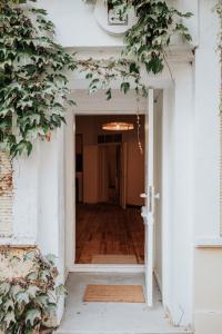 an open door leading into a hallway with trees at Gaudyhouse in Berlin
