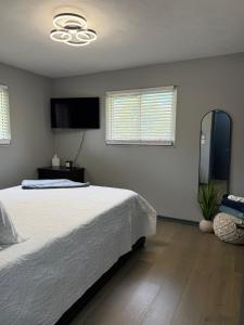 インディアナポリスにあるDelightful 3 Bd Home with King size bed, hot tub, playground!の白いベッドとテレビのある寝室