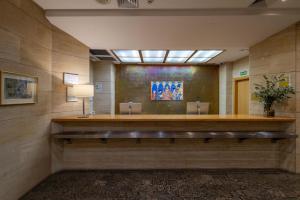 a waiting room with a bench in a building at Eurostars Rey Alfonso X in Ciudad Real