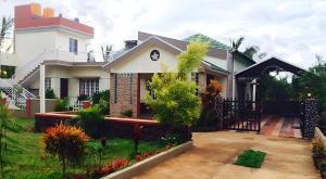 a house with a garden in front of it at Green Leaf Nature HomeStay in Santaveri