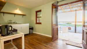 a kitchen with a door open to a patio at Bergriver Nest in Velddrif