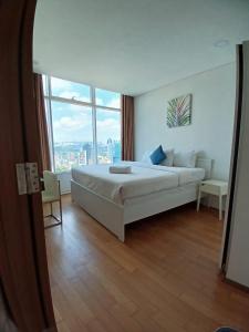 Ένα ή περισσότερα κρεβάτια σε δωμάτιο στο VORTEX KLCC by PRIME SUITES