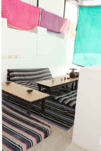 a room with two tables and rugs at Shiva Guest House in Pushkar