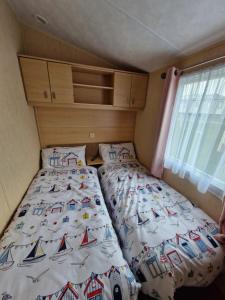 a bedroom with two beds in a small room at Ocean Front Lodge in Hartlepool