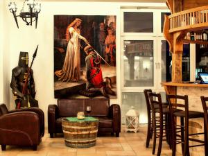 a living room with a large painting on the wall at Hasseröder Burghotel in Wernigerode
