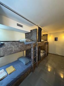 a room with two bunk beds in a room at Hostel VOYAGE in Batumi