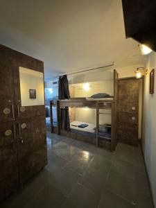 a room with two bunk beds and a mirror at Hostel VOYAGE in Batumi