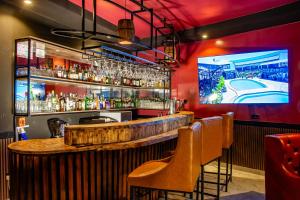 a bar with a wooden counter and a tv at Avian Court Hotel in Naivasha