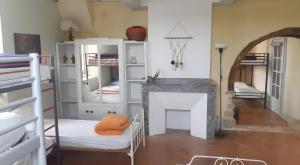 a room with a fireplace and a room with bunk beds at Gite Le Marquès in Coueilles +10 photos