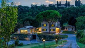 a home in the hills with lights on at Casale Astralis 13 by Marche Holiday Villas in Saltara
