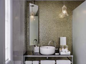 a bathroom with a sink and a mirror at Fable Auckland, MGallery in Auckland