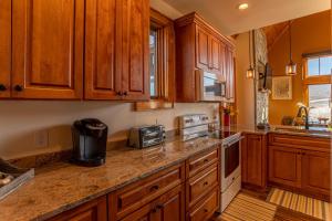 a kitchen with wooden cabinets and a counter top at Mio Nido at Eagles Nest in Newland +30 photos