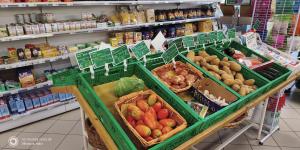 a produce section of a grocery store with baskets of fruits and vegetables at casa vacanze Villanova - 4 posti letto in Villanova +10 photos