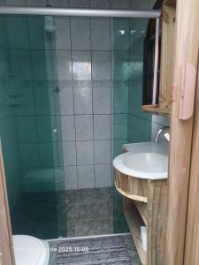a bathroom with a glass shower and a sink at Pousada e Hostel La Civetta - Maresias in São Sebastião +23 photos
