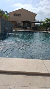 a large pool of water in front of a house at Domaine du PIAOU "chambres & table d'hôte" in Le Val