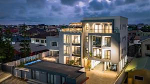 a large white building with a lot of windows at Grey Assets - Apartment 1 in Spintex