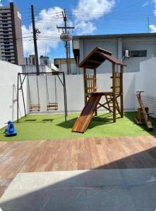 a playground on a roof with a swing at Apartamento amplo e equipado, entre a praia e o centro in João Pessoa