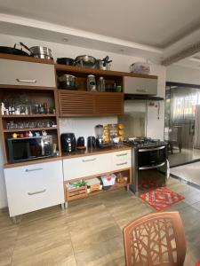 a kitchen with white cabinets and a stove at Casa Cop 30 in Belém