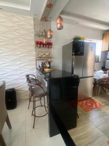 a kitchen with a refrigerator and a table and chairs at Casa Cop 30 in Belém +3 photos