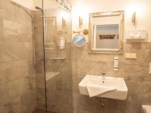 a bathroom with a sink and a shower at Hasseröder Burghotel in Wernigerode +52 photos