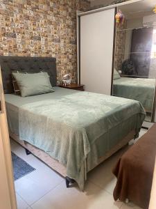 a bedroom with a bed and a brick wall at Casa Cop 30 in Belém +3 photos