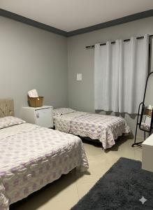 En eller flere senge i et værelse på Recanto do Aconchego Prime