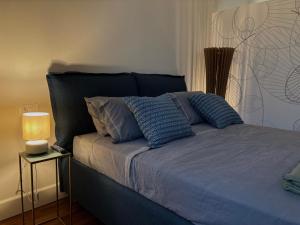a bed with blue sheets and pillows in a bedroom at Partifour in Bergamo