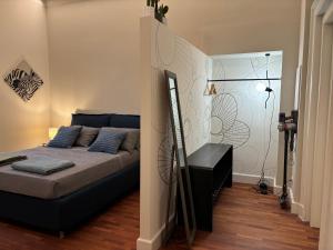 a bedroom with a bed with blue pillows at Partifour in Bergamo +43 photos