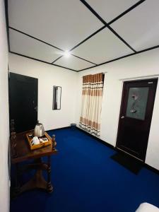 a room with a blue floor and a table at The Crowns Lodge in Nuwara Eliya +17 photos