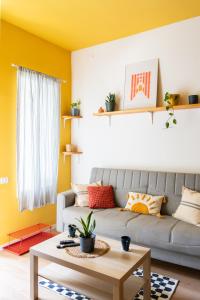 a living room with a couch and a table at Dotan's Boutique Studios - By The Beach! in Tel Aviv +84 photos