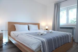 a bedroom with a large bed with towels on it at Appartements Lena. in Premantura