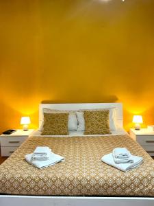 a bedroom with a bed with two towels on it at BACCANO Guest House in Montepulciano
